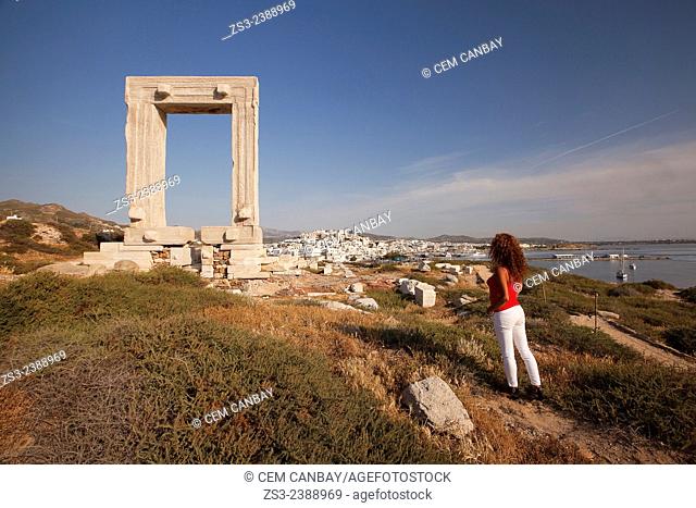 Tourist at the famous Portara door in town center, Naxos, Cyclades Islands, Greek Islands, Greece, Europe