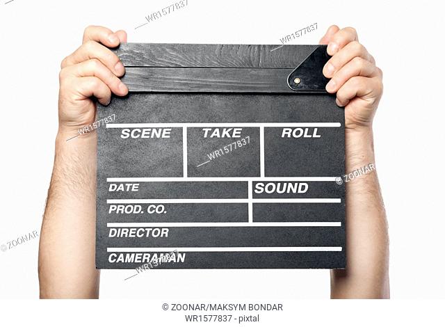 two male hands holding movie production clapper