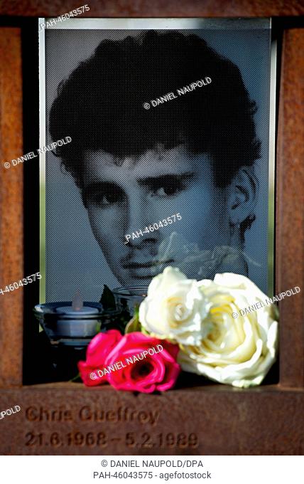 Flowers and candles lie in front of a picture of Chris Gueffrey which has been placed at the Berlin Wall Memorial in Berlin, Germany, 05 February 2014