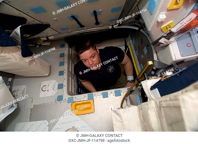 NASA astronaut Robert Behnken, STS-130 mission specialist, is pictured in the hatch which connects the flight deck and middeck of space shuttle Endeavour during...