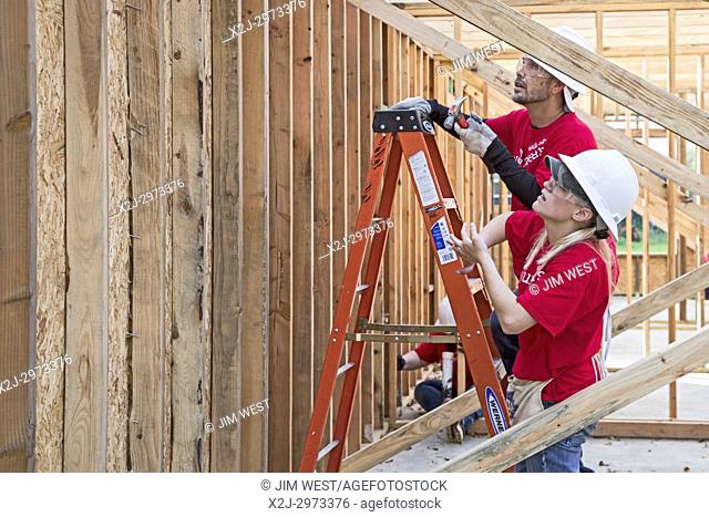 Houston, Texas - Volunteers from Wells Fargo Bank help build a Habitat for Humanity house for a low-income family. The need for affordable housing in the...