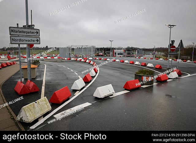 PRODUCTION - 13 December 2023, Hamburg: Concrete barriers secure an entrance to the airfield at the north gate of Hamburg Airport