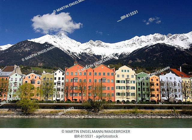 Row of buildings on Mariahilf Street along the Inn River, snow covered Karwendel Mountain Range of the Alps at back, Historic centre of Innsbruck, Inntal Valley