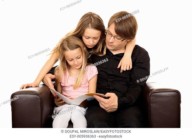 Family reading a story before going sleeping in a brown designed armchair. Isolated on white background