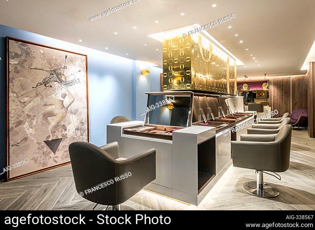 Haircut stations in a luxury hair salon between ground floor and basement with bespoke furniture located in the heart of Soho, London, UK