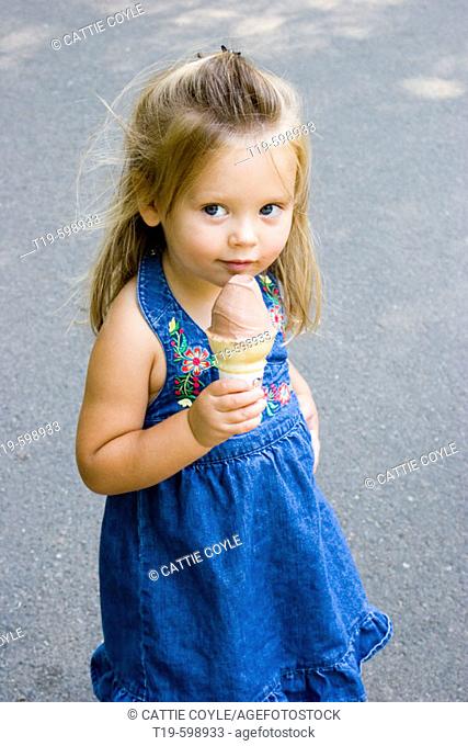 3-year old girl with an ice cream cone in Boston Public Garden. USA