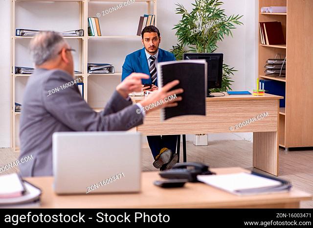 Two male colleagues working in the office workplace