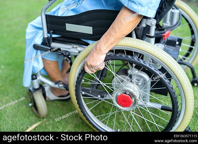 Asian senior woman patient on electric wheelchair at hospital, healthy strong medical concept