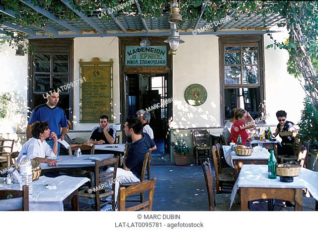 Aegean. Mytilini. Traditional taverna, restaurant terrace. Vine covered roof. People seated. Ouzeri Ermis