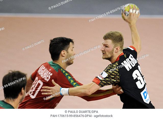 GermanyÂ·s Philipp Weber, right, challenges PortugalÂ·s Fabio Magalhaes for the ball during the Euro 2018 Qualification Group 5 handball match between Portugal...