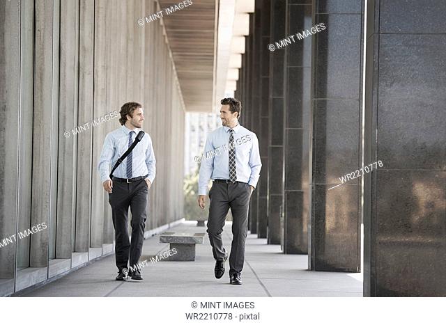 Two businessmen walking along a city street