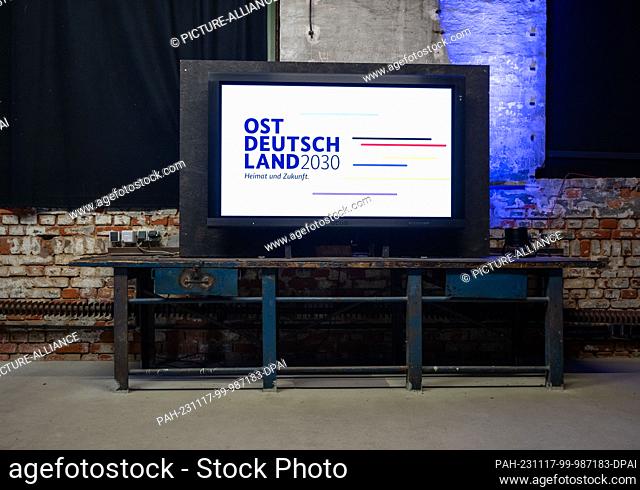 17 November 2023, Saxony, Leipzig: A monitor with the logo of the ""East Germany 2030"" conference stands on a workbench in the Kunstfraftwerk in Leipzig