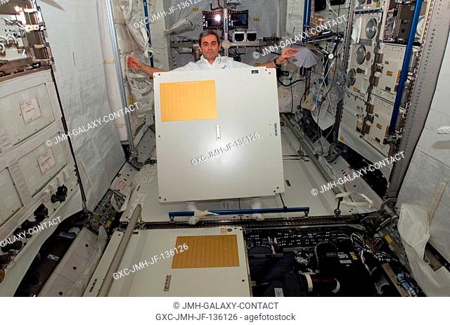 European Space Agency (ESA) astronaut Leopold Eyharts, Expedition 16 flight engineer, holds a panel in the newly attached Columbus laboratory of the...