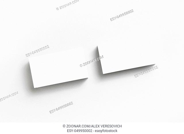 Blank business cards on paper background. Mockup for branding identity. Studio shot. Top view