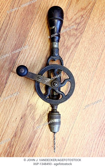 An antique hand cranked drilling tool