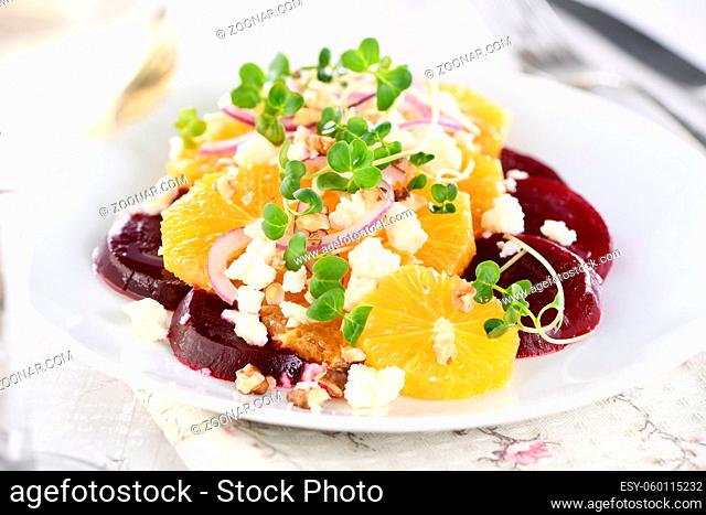 Orange salad with baked beetroot, goat cheese, microgreens and nuts. Perfect as a side dish or as a light lunch for a brunch or dinner