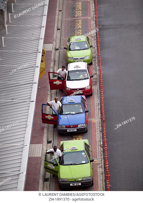 Taxi drivers pushing their car at a pick up zone in Kuala Lumpur Malaysia