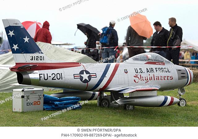 Visitors at the ""Mega Flugshow"" air show standing behind a model ""U.S. Air Force FU-201"" plane in Goettingen, Germany, 2 September 2017