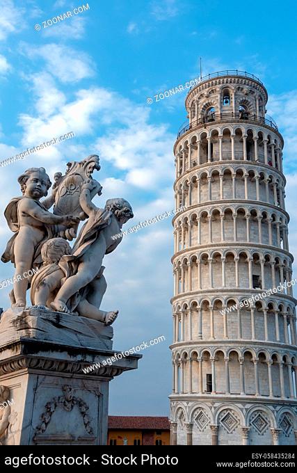 PISA, TUSCANY/ITALY - APRIL 17 : Statue of cherubs in front of the Leaning Tower of Pisa Tuscany Italy on April 17, 2019. Three unidentified people