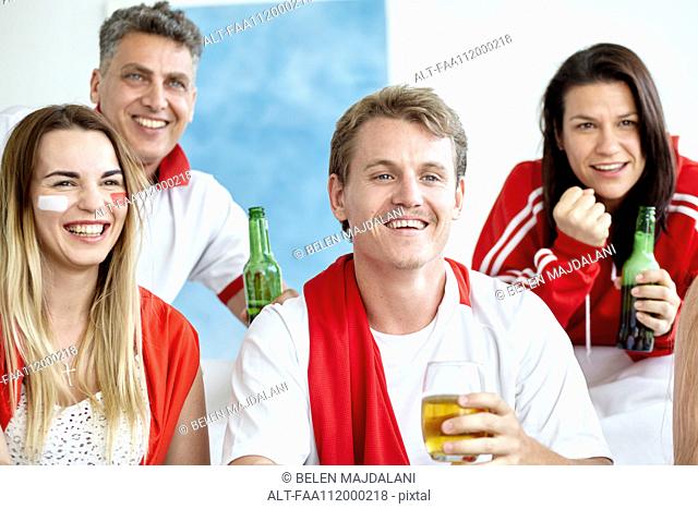 Sports enthusiasts watching match and drinking beer