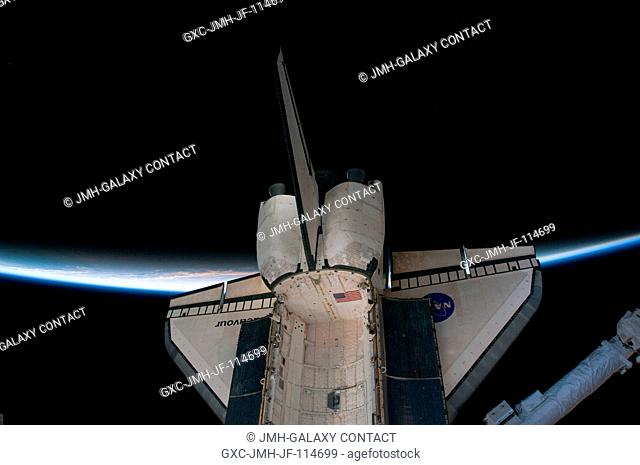 Intersecting the thin line of Earth's atmosphere, space shuttle Endeavour is featured in this image photographed by an STS-130 crew member while Endeavour...