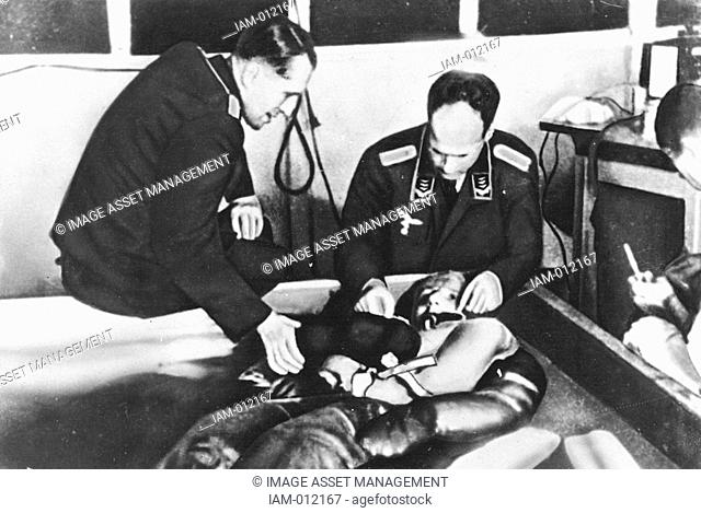 Cold water immersion during hypothermia experiments at Dachau concentration camp presided over by Professor Holzlohner left and Dr Rascher right