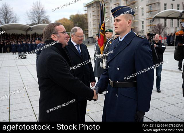 12 November 2023, Berlin: Boris Pistorius (SPD, l), Federal Minister of Defense, congratulates recruits at the ceremonial pledge to mark the 68th anniversary of...