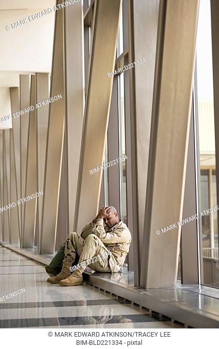 African American soldier sitting in airport