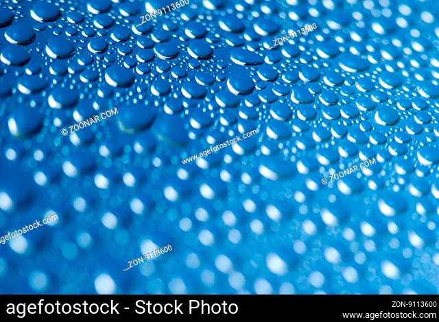 close-up of water drops on the blue background