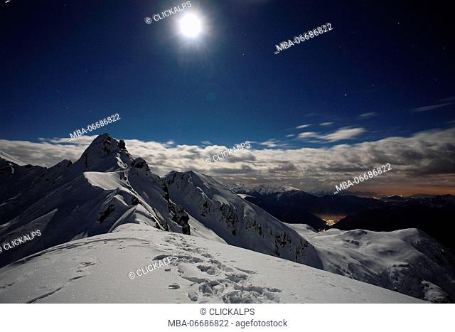 Full moon at Salmurano mountain on the Orobie alps, Lombardy, italy