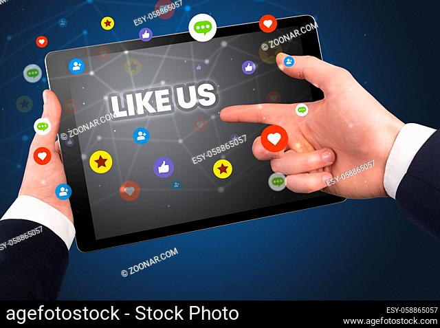 Close-up of a touchscreen with LIKE US inscription, social networking concept