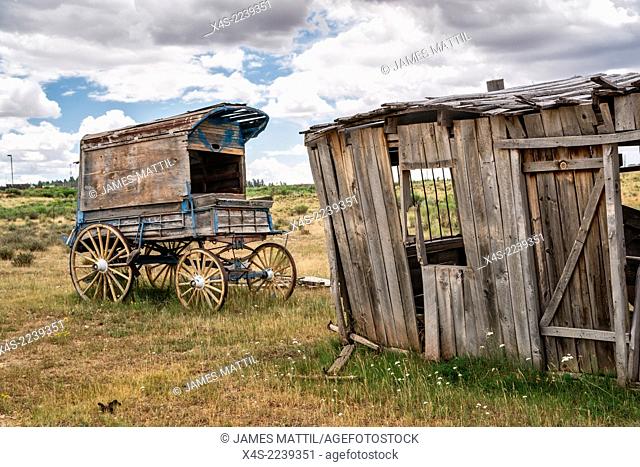 An old west sheriff's wagon sits on the lonesome frontier prarie as storm clouds gather in the distance