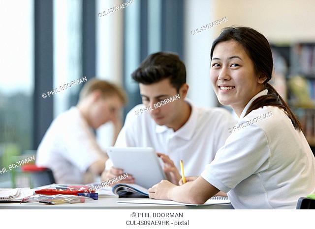 Teenagers working in school classroom