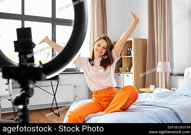 girl blogger with ring light streaming at home