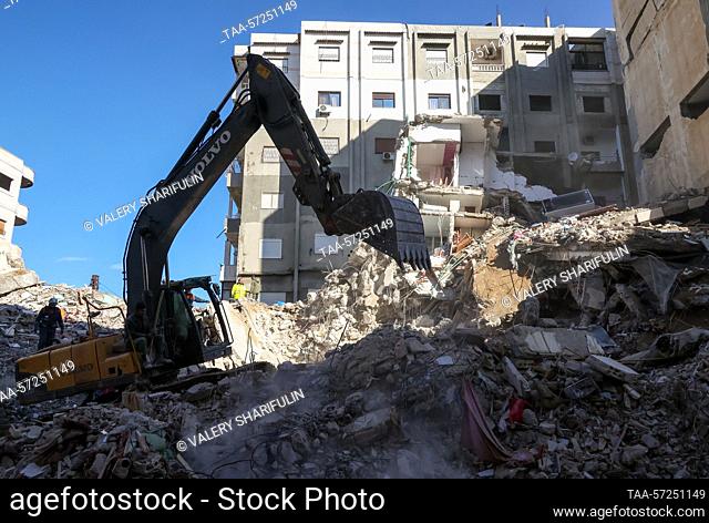 SYRIAN ARAB REPUBLIC, JABLEH - FEBRUARY 8, 2023: Emergency service workers clear the rubble after an earthquake. A major earthquake measuring 7