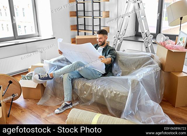happy man with blueprint moving to new home