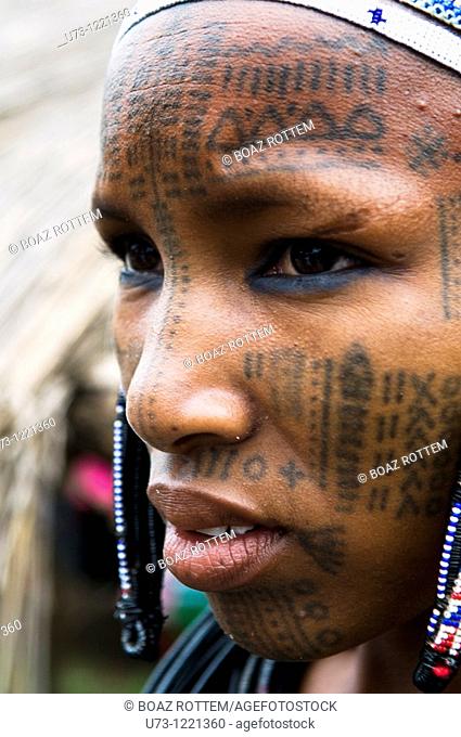 A Beautiful Peul / Fulani girl covered with facial tattoos in the Benin / Niger border area