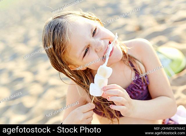 Girl eating roasted marshmallows