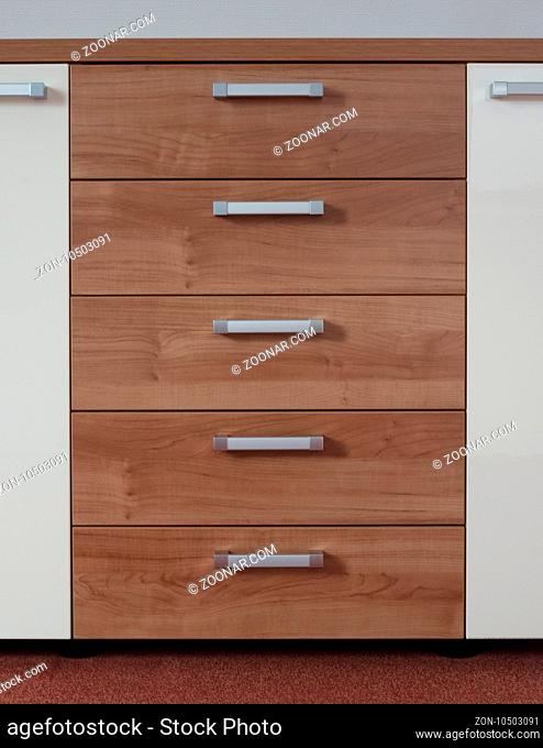 Modern cupboard with drawers, selective focus, metal handles