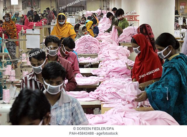 Women and men work in the textile factory 'One Composite Mills' in Gazipur, a suburb of Dhaka, Bangladesh, 03 January 2014