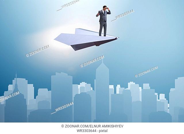 Businessman flying on paper plane in business concept