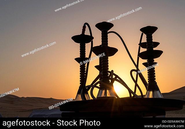 Arab shishas (Water pipes) on a table in the desert at sunset, Abu Dhabi, UAE