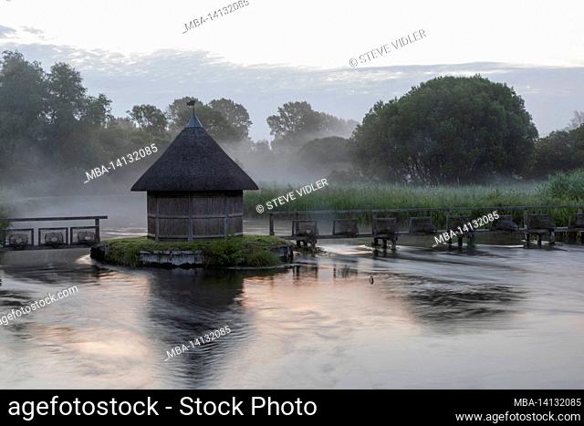 england, hampshire, test valley, stockbridge, longstock, leckford estate, river test and traditional thatched fisherman's hut