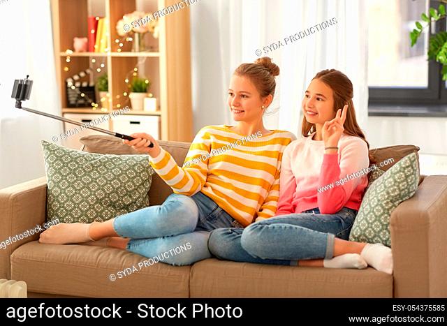 happy girls taking selfie with smartphone at home