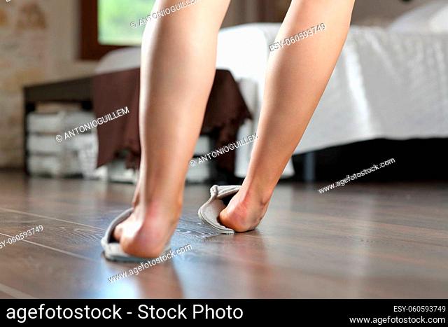 Back view close up of a woman legs stumbling in the bedroom