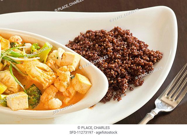 Vegan Panang curry with tofu, vegetables and quinoa (close-up)