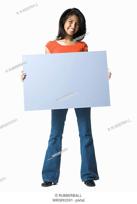 Portrait of a young woman holding a blank sign