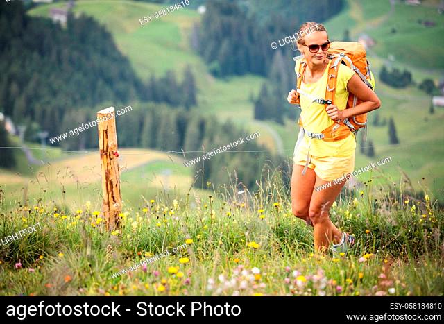 Pretty, female hiker in Swiss Alps