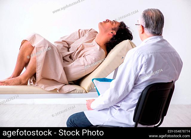 The aged male doctor psychiatrist examining young patient