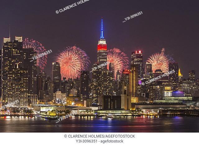 WEEHAWKEN, NJ - JULY 4: The annual Macy's Fourth of July fireworks show lights the sky behind the Manhattan skyline on Tuesday, July 4
